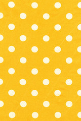Natural cotton texture background. Yellow polka dot textile