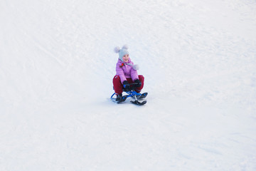 Fototapeta na wymiar girl motion on a snow scooter