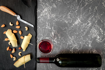 red wine with cheese on dark background top view