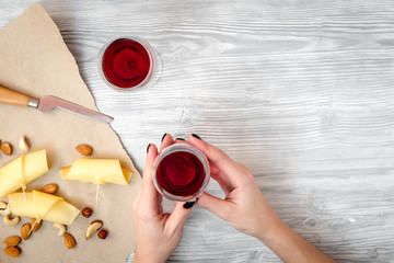 red wine with cheese on wooden background top view