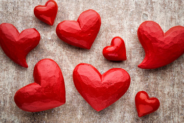 Red heart on the wooden background.