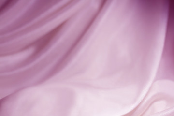 Smooth elegant pink silk or satin texture can use as wedding background. Luxurious Valentine day background design.