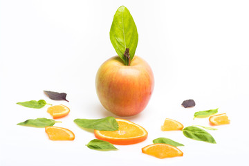 green mint leaves, apple and orange dessert isolated on white