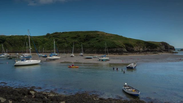 epic timelapse shot filmed over 7 hours of  the port of Solva in Wales. during this long period of time the water empties out of the bay into the sea leaving the boats stranded in sand