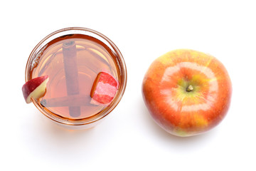 apple tea or mulled wine with cinnamon isolated on white