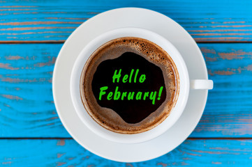 HELLO FEBRUARY - written on morning coffee mug. Top view. Last winter month