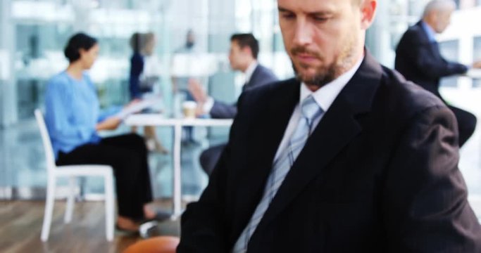 Businessman using digital tablet in office 4k