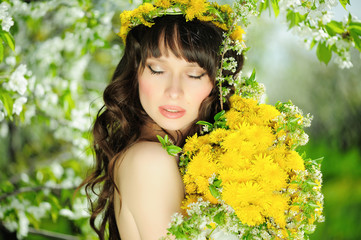 delicate and beautiful woman to spring flowering gardens