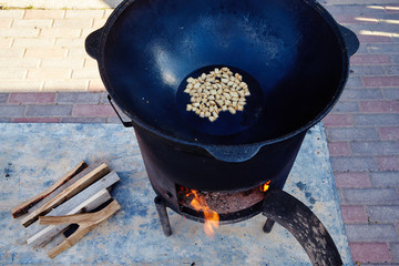 National Uzbek dish pilaf, pilaw, plov, rice with meat in big pan. Cooking in a cauldron on open...