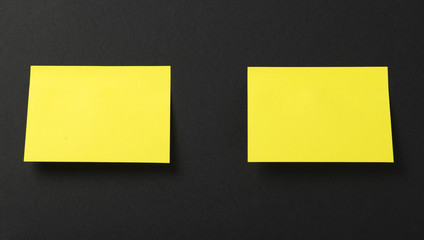 Two yellow post-it on black background