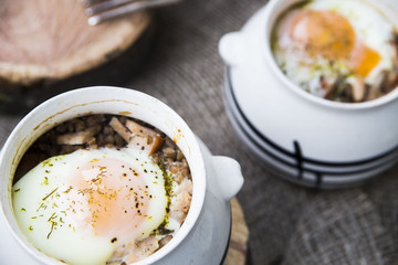 rural eggs baked in pots for two - lie on wooden frame