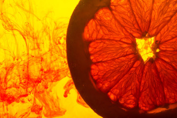 close up of a grapefruit slice in water