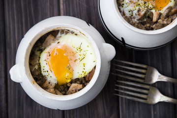 rural eggs baked in pots for two - lie on wooden frame