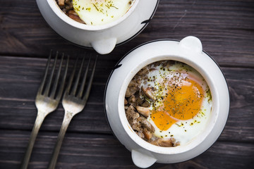 rural eggs baked in pots for two - lie on wooden frame