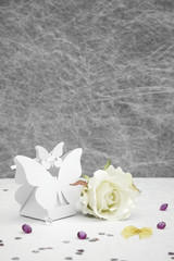 Fototapeta na wymiar Wedding Favor butterfly shape boxes on a White tablecloth