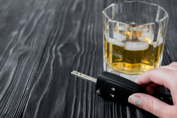 concept of alcohol and driving on wooden background