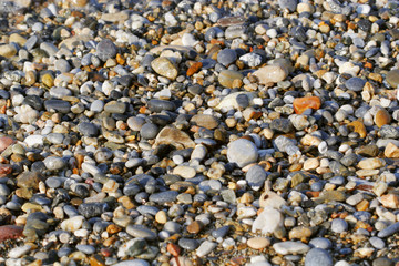  A close up view of smooth polished multicolored stones washed a