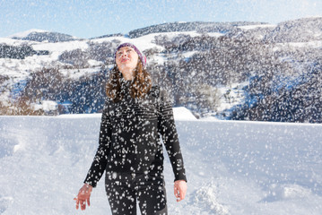 Fototapeta na wymiar Girl standing in heavy snow on the mountain