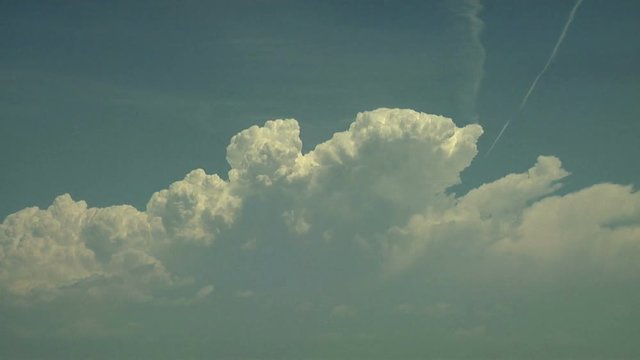Jet Plane Avoiding Thunderhead Cloud