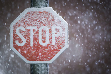 Stop sign at snowfall