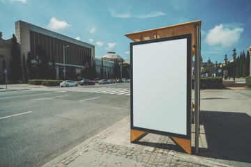 Empty mock up banner for your advertising, blank billboard with copy space area for your text message or promotional content, public information board in urban setting with road and crosswalk around