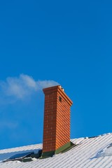 Chimney on rooftop of house in winter