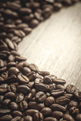 Close-up of coffee beans on wooden background