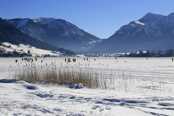 Fototapeta na wymiar Winterlandschaft: Sportliche Aktivitäten auf dem zugefrorenen See