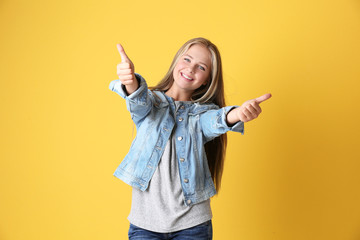 Beautiful teenager girl on yellow background