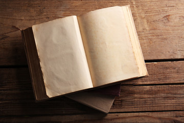 Old books on wooden background, top view