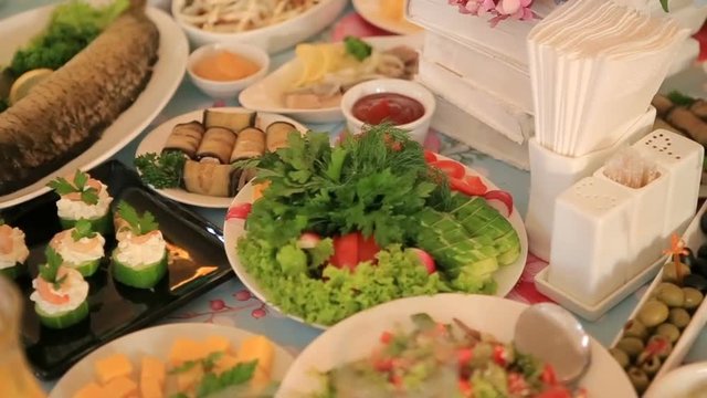 Vegetables and fish served on white dinner table