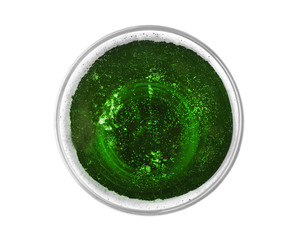 Glass with cold green beer on white background, top view. Saint Patrick's Day concept