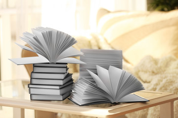 Stack of new books on table in living room