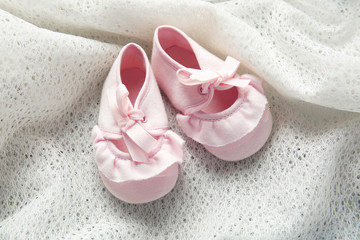 New children shoes on textile background