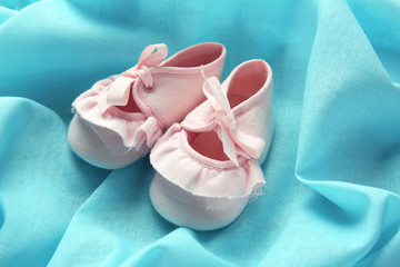 New children shoes on blue textile background