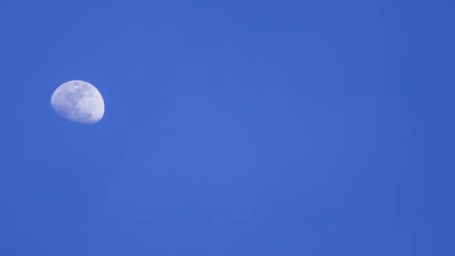 panning shot of Moon on the sky blue