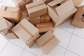 House move concept. Carton boxes on tile floor background