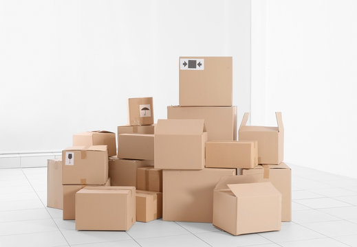 House move concept. Carton boxes on white wall background