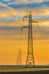 Dawn on high voltage pylons