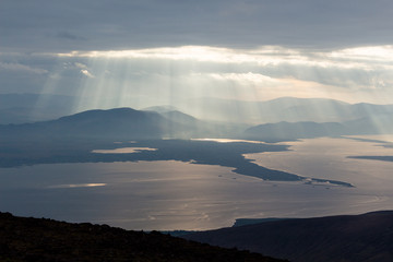 Shafts of sunlight on Castlemaine Harbour and Iveragh Peninsula, County Kerry, Ireland