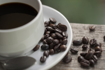 coffee cup and coffee bean on wooden background