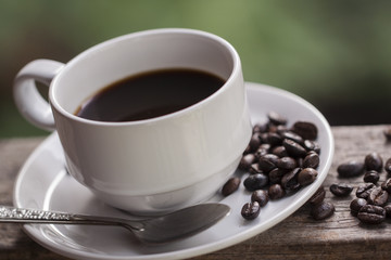 coffee cup and coffee bean on wooden background