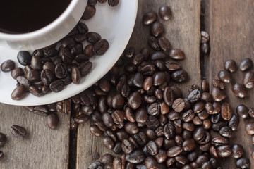 coffee cup and coffee bean on wooden background