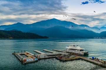 Beautiful Landscape of Sun Moon Lake in the morning with blue mountain background. Tourist likes to visit the beautiful attractions around the sun moon lake by boat cruise
