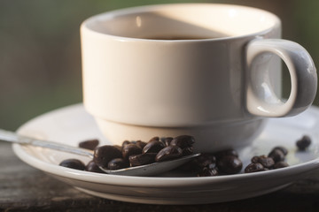 coffee cup and coffee bean on wooden background