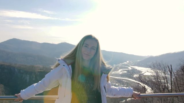 skybridge observation deck. Portrain of woman enjoing sunlight and scenery view of the mountains