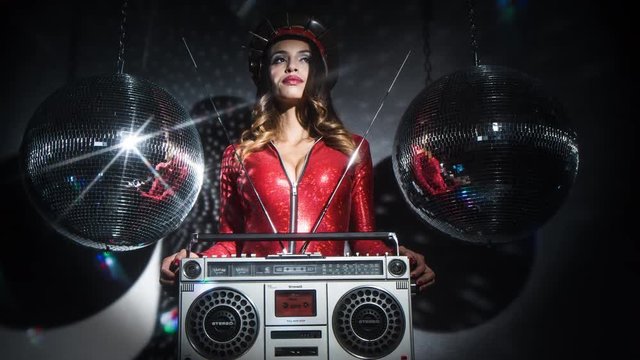 sexy cool latina woman posing in amazing red catsuit with  spiked military hat and vintage ghettoblaster