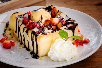 Ripe strawberry with toast and ice cream on white plate