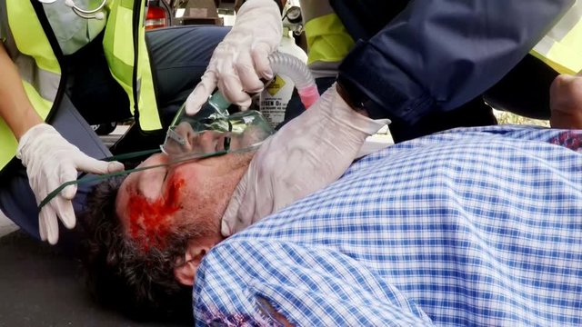 Paramedic using an external defibrillator 