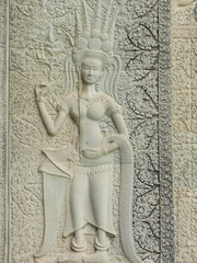 Stone carving of an angel or Apsara on the wall of Angkor Wat, the 12th century Hindu temple complex in Cambodia